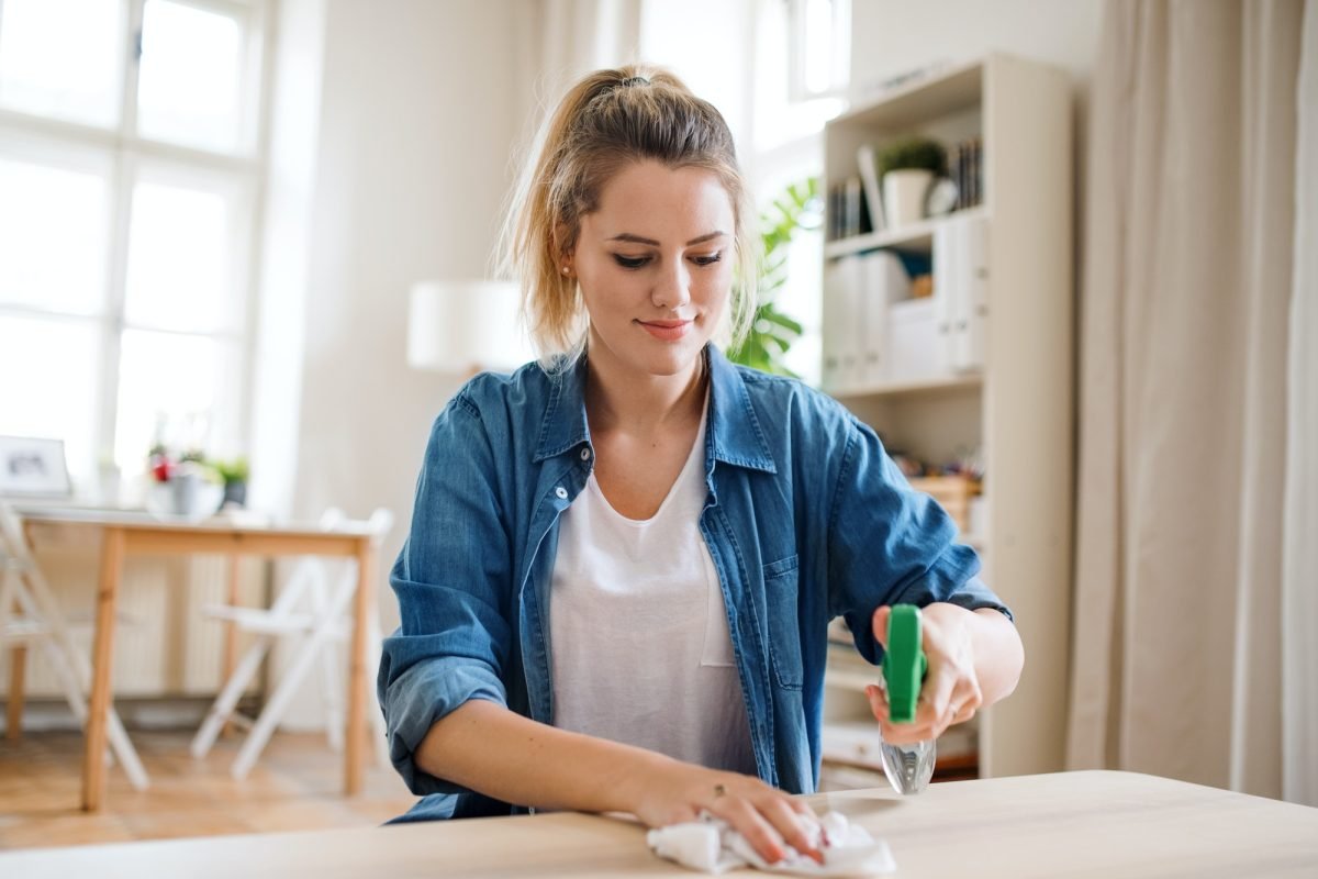 young-woman-indoors-at-home-cleaning-table-.jpg